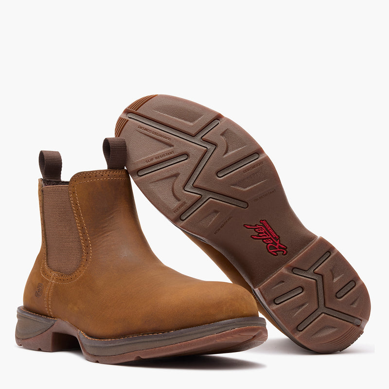 Outsole view of a pair of Durango Red Dirt Rebel brown round toe chelsea boots
