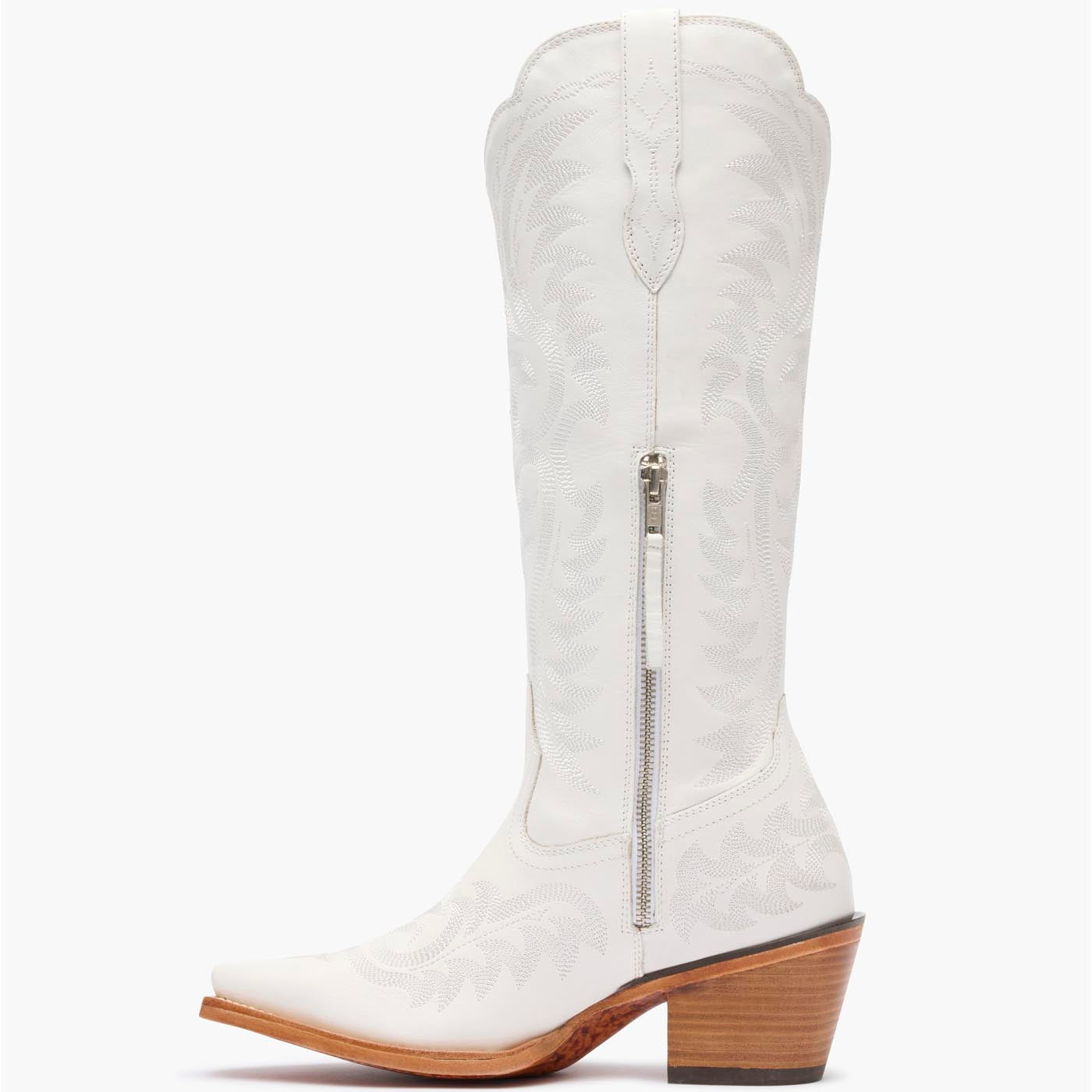 Inner side view of Durango white cowgirl boots with white stitching and zipper.